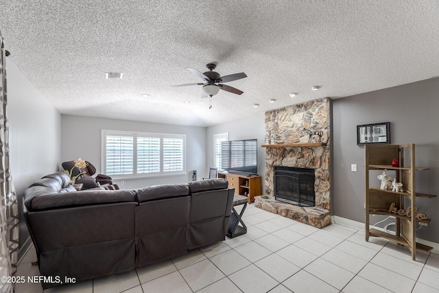 806 Falkirk Ct, Orange Park, FL 32073 - living room with a ceiling fan, a fireplace, light tile patterned floors, a textured ceiling, and baseboards