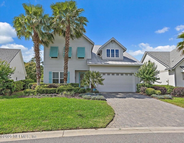 433 Marsh Cove Dr, Ponte Vedra Beach, FL 32082 - view of front of property with a front lawn, decorative driveway, an attached garage, and metal roof
