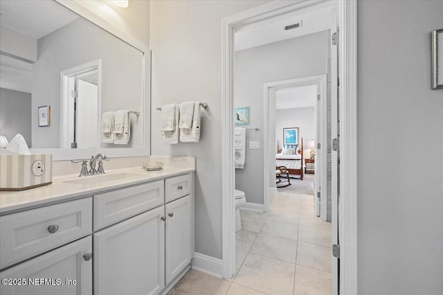 433 Marsh Cove Dr, Ponte Vedra Beach, FL 32082 - bathroom featuring toilet, vanity, tile patterned flooring, ensuite bath, and baseboards