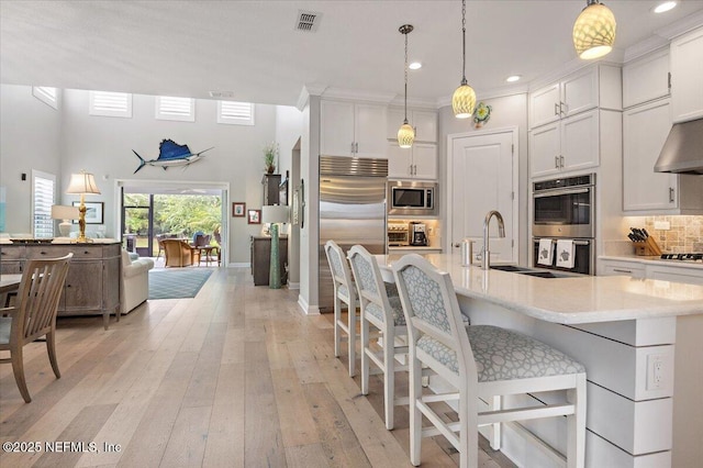 433 Marsh Cove Dr, Ponte Vedra Beach, FL 32082 - kitchen with built in appliances, white cabinets, tasteful backsplash, and recessed lighting