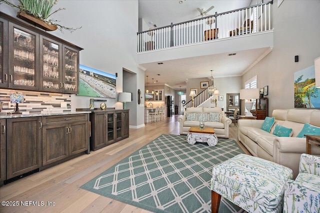 433 Marsh Cove Dr, Ponte Vedra Beach, FL 32082 - living room with a towering ceiling, light wood-style floors, and a chandelier