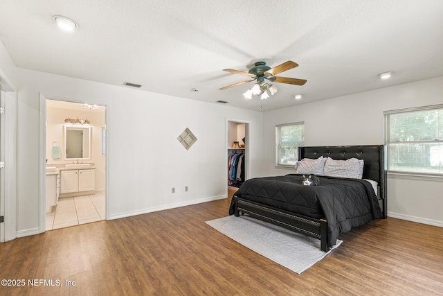 120 Stokes Landing Rd, Saint Augustine, FL 32095 - bedroom featuring wood finished floors, baseboards, a spacious closet, a sink, and a closet