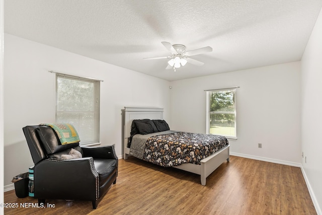 120 Stokes Landing Rd, Saint Augustine, FL 32095 - bedroom with wood finished floors, baseboards, a ceiling fan, and a textured ceiling