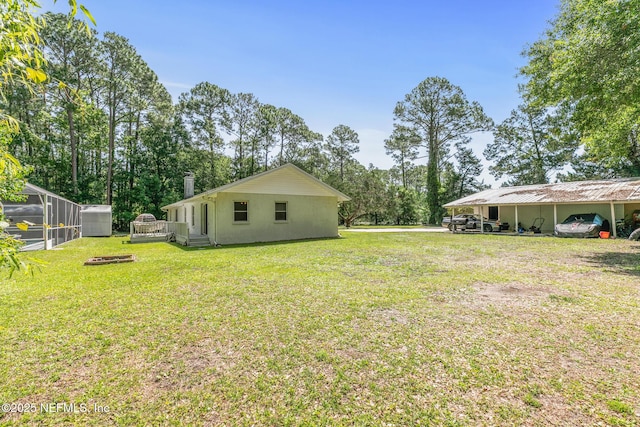120 Stokes Landing Rd, Saint Augustine, FL 32095 - view of grassy yard featuring view of wooded area and a carport
