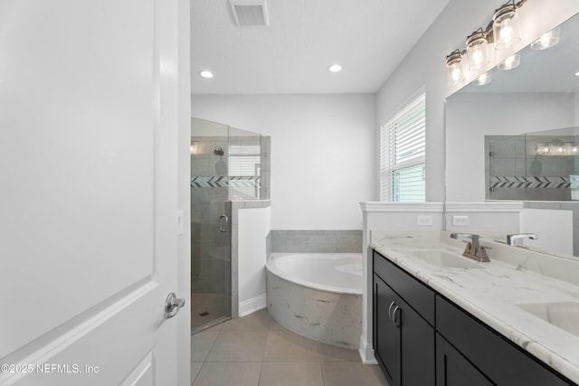 bathroom with a shower stall, tile patterned flooring, a bath, double vanity, and recessed lighting