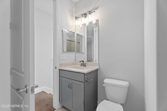 half bath featuring toilet and vanity