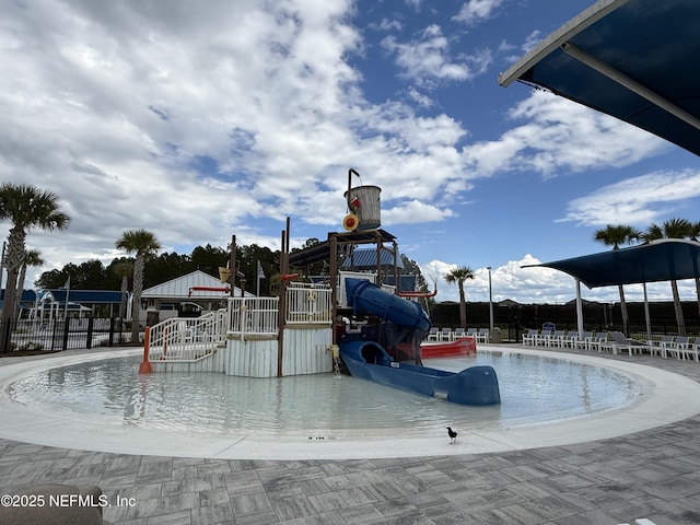 view of swimming pool with fence