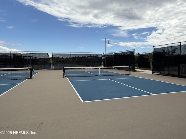 view of tennis court with fence