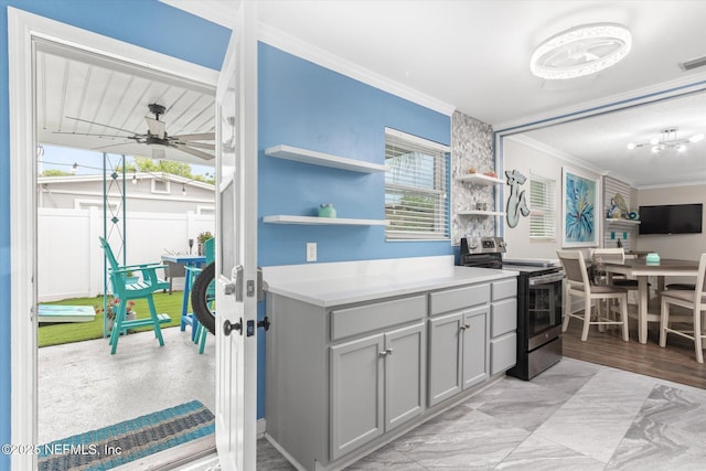 kitchen featuring stainless steel range with electric cooktop, ornamental molding, open shelves, gray cabinets, and a ceiling fan