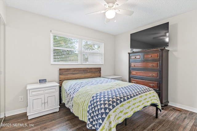 bedroom featuring dark wood-type flooring, baseboards, and ceiling fan