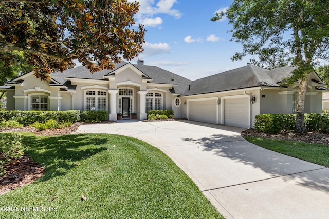 724 Piney Pl, Saint Johns, FL 32259 - french country home featuring stucco siding, a garage, driveway, a front lawn, and a shingled roof