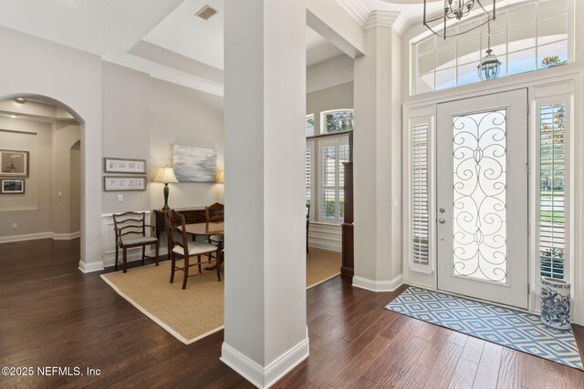 724 Piney Pl, Saint Johns, FL 32259 - entrance foyer with dark wood-style floors, arched walkways, baseboards, crown molding, and a towering ceiling