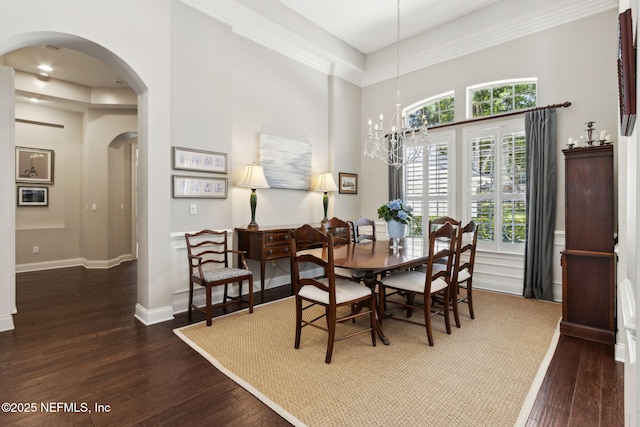 724 Piney Pl, Saint Johns, FL 32259 - dining room with arched walkways, wood finished floors, a high ceiling, a chandelier, and baseboards