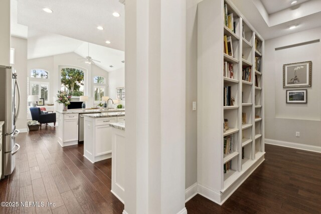 724 Piney Pl, Saint Johns, FL 32259 - hallway with dark wood-style floors, baseboards, recessed lighting, lofted ceiling, and a sink