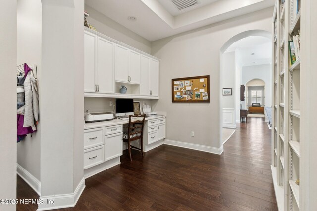 724 Piney Pl, Saint Johns, FL 32259 - home office with arched walkways, built in study area, dark wood-type flooring, and baseboards