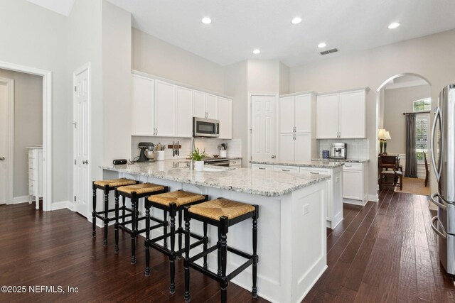 724 Piney Pl, Saint Johns, FL 32259 - kitchen with appliances with stainless steel finishes, a peninsula, tasteful backsplash, white cabinetry, and recessed lighting