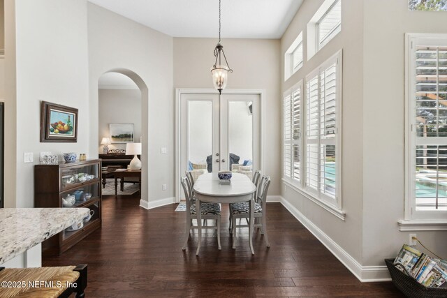 724 Piney Pl, Saint Johns, FL 32259 - dining room with arched walkways, dark wood-type flooring, baseboards, and a chandelier