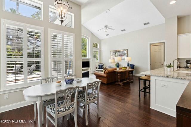 724 Piney Pl, Saint Johns, FL 32259 - dining space with high vaulted ceiling, ceiling fan, dark wood finished floors, and baseboards