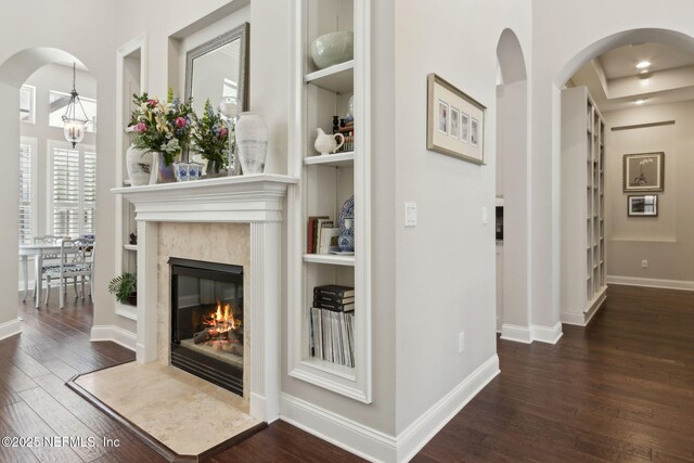 724 Piney Pl, Saint Johns, FL 32259 - living area featuring wood finished floors, arched walkways, a high end fireplace, baseboards, and healthy amount of natural light