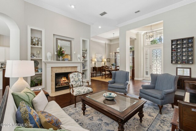 724 Piney Pl, Saint Johns, FL 32259 - living room featuring a chandelier, plenty of natural light, wood finished floors, built in features, and ornamental molding