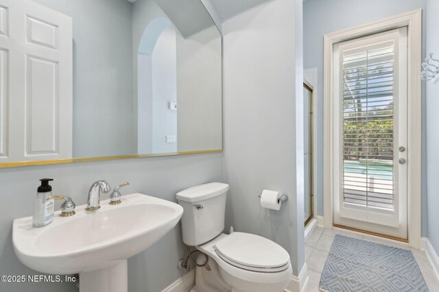 724 Piney Pl, Saint Johns, FL 32259 - bathroom featuring toilet, an enclosed shower, a sink, baseboards, and tile patterned flooring