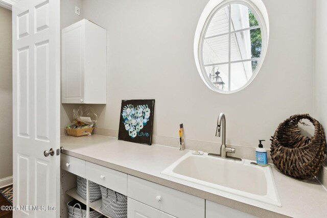 724 Piney Pl, Saint Johns, FL 32259 - kitchen with a sink, white cabinets, and light countertops