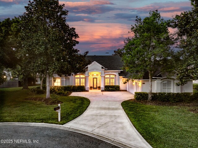 724 Piney Pl, Saint Johns, FL 32259 - view of front facade with driveway, an attached garage, a lawn, and stucco siding