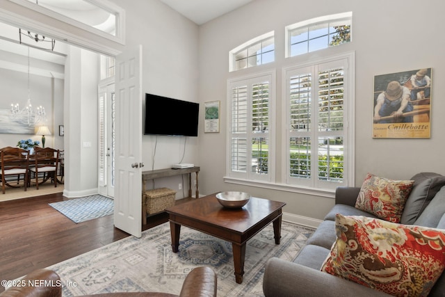 724 Piney Pl, Saint Johns, FL 32259 - living area with a chandelier, wood finished floors, and baseboards