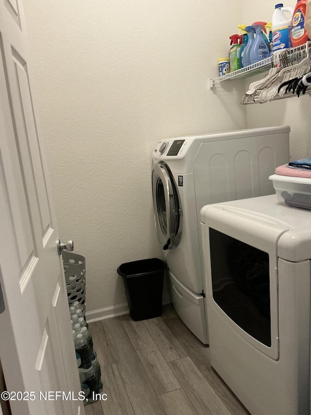 10470 Collins Field Cir, Jacksonville, FL 32222 - laundry area with washing machine and dryer, wood finished floors, and baseboards