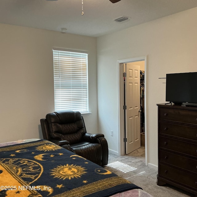 10470 Collins Field Cir, Jacksonville, FL 32222 - bedroom with light carpet, a walk in closet, and baseboards
