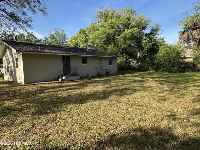 1457 Bassett Rd, Jacksonville, FL 32208 - back of house with a yard