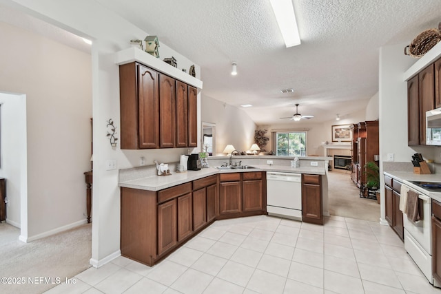 324 Hammock Grove Ct, Saint Johns, FL 32259 - kitchen featuring white appliances, a sink, a peninsula, light countertops, and a textured ceiling