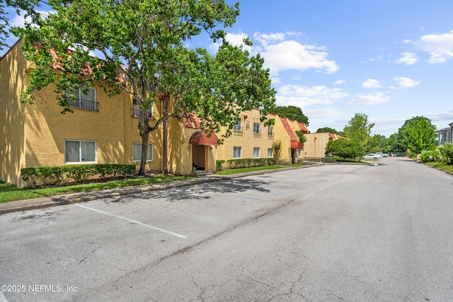 6552 La Mirada Dr E Unit 7, Jacksonville, FL 32217 - view of asphalt road with curbs and a residential view