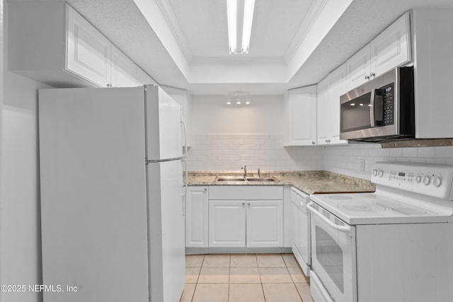 6552 La Mirada Dr E Unit 7, Jacksonville, FL 32217 - kitchen featuring white appliances, a raised ceiling, a sink, ornamental molding, and white cabinets