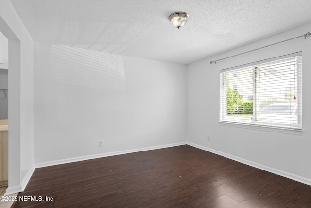 6552 La Mirada Dr E Unit 7, Jacksonville, FL 32217 - empty room featuring wood finished floors, a textured ceiling, and baseboards