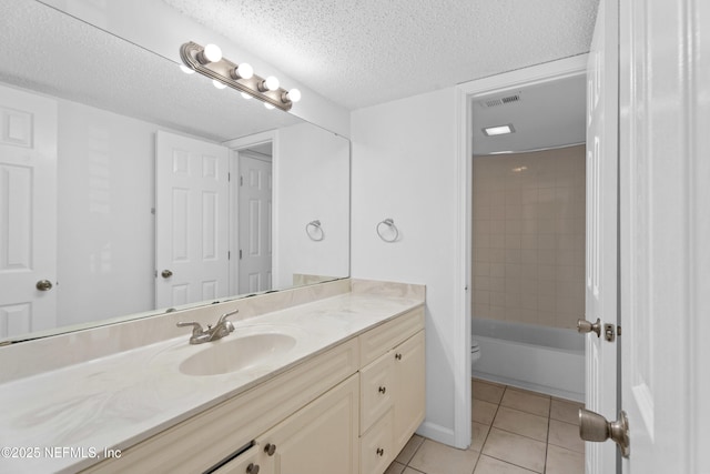 6552 La Mirada Dr E Unit 7, Jacksonville, FL 32217 - full bathroom featuring tile patterned floors, vanity, toilet, and a textured ceiling