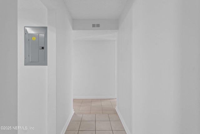 6552 La Mirada Dr E Unit 7, Jacksonville, FL 32217 - corridor featuring electric panel, light tile patterned flooring, and baseboards