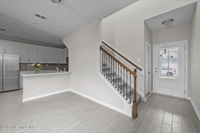 698 Cherry Elm Dr, Saint Augustine, FL 32092 - entryway with baseboards, light wood finished floors, and stairway