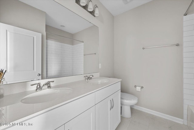 698 Cherry Elm Dr, Saint Augustine, FL 32092 - full bathroom with toilet, baseboards, double vanity, marble finish floors, and bathtub / shower combination