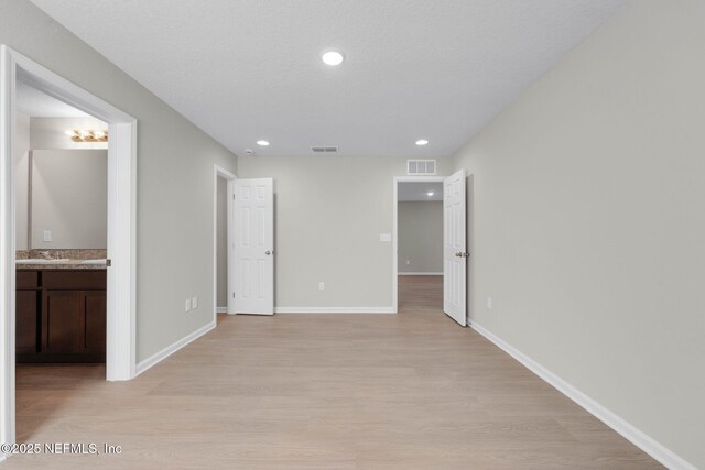 5420 Arlington Rd, Jacksonville, FL 32211 - unfurnished bedroom with light wood-type flooring, baseboards, ensuite bathroom, and recessed lighting