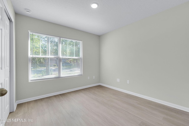 5420 Arlington Rd, Jacksonville, FL 32211 - empty room with light wood-style floors, plenty of natural light, and baseboards
