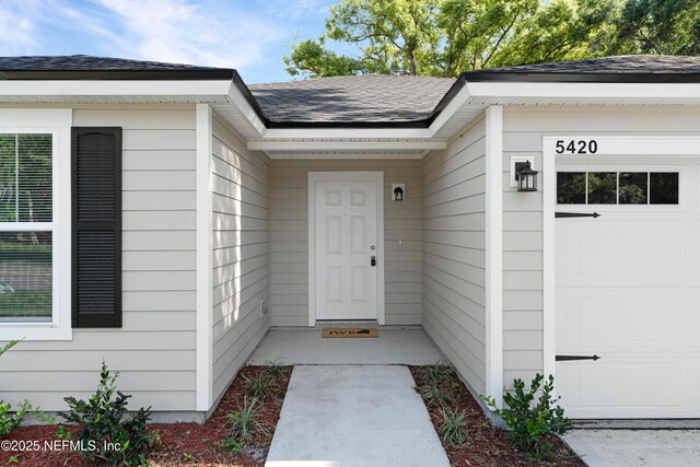 5420 Arlington Rd, Jacksonville, FL 32211 - entrance to property featuring a garage and roof with shingles