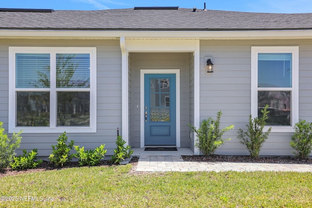 478 Cherry Elm Dr, Saint Augustine, FL 32092 - view of exterior entry with a yard and roof with shingles