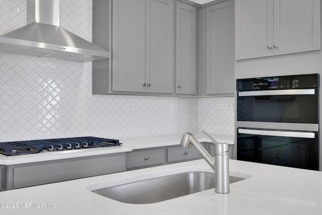 478 Cherry Elm Dr, Saint Augustine, FL 32092 - kitchen with gray cabinets, wall chimney exhaust hood, a sink, stainless steel gas stovetop, and backsplash
