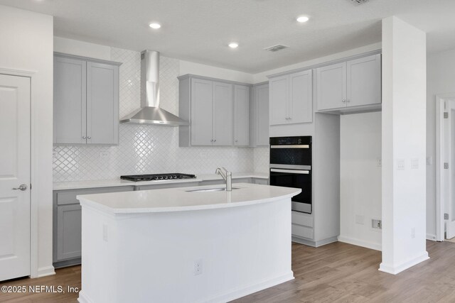 478 Cherry Elm Dr, Saint Augustine, FL 32092 - kitchen with wall chimney range hood, gray cabinetry, black appliances, a sink, and recessed lighting