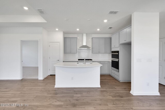 478 Cherry Elm Dr, Saint Augustine, FL 32092 - kitchen featuring wall chimney range hood, gray cabinets, recessed lighting, backsplash, and light countertops