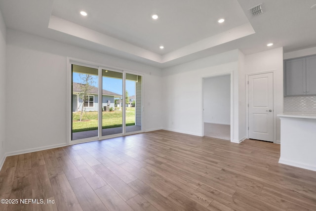 478 Cherry Elm Dr, Saint Augustine, FL 32092 - empty room featuring a tray ceiling, light wood-style flooring, recessed lighting, and baseboards