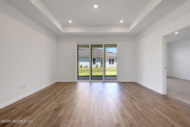 478 Cherry Elm Dr, Saint Augustine, FL 32092 - unfurnished room featuring a tray ceiling, wood finished floors, baseboards, and recessed lighting