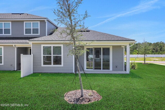 478 Cherry Elm Dr, Saint Augustine, FL 32092 - back of property featuring a lawn and roof with shingles