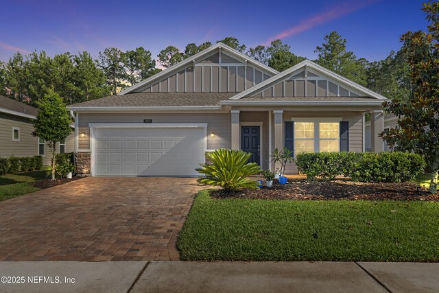 383 Saint Vincent Dr, Saint Augustine, FL 32092 - view of front facade featuring board and batten siding, an attached garage, and decorative driveway